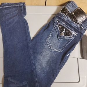 Red Rivet jeans w/ embellishments.